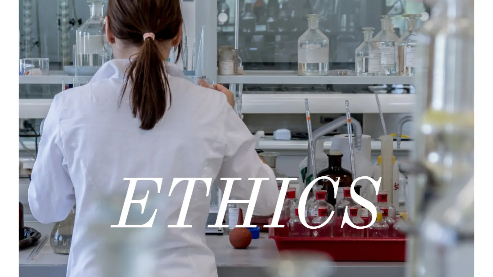 Picture of research being performed in a lab with the word "ethics" as the accompanying text